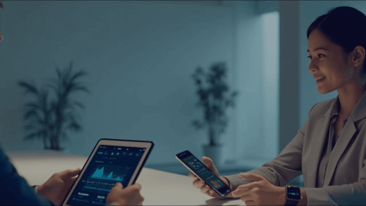 Two colleagues reviewing business data together in a bright modern office